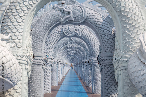 Walkway through arched pillars in the form of Naga serpents, at the temple of Wat Don Yai, northeast of Bangkok, Thailand.