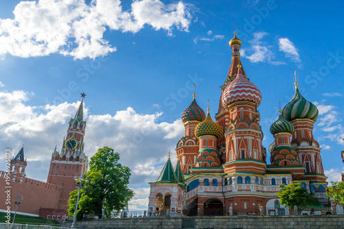 Moscow tourist landmarks: Saint Basil’s Cathedral and Kremlin Spasskaya Tower in Russia, symbol of Russian history, faith, power and urban culture.
