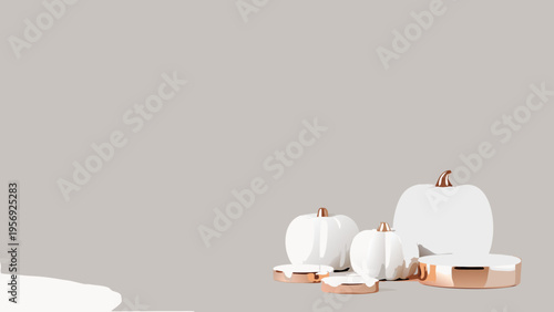 Minimalist still life featuring white pumpkins and rose gold accents