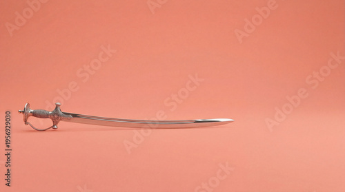 Wallpaper Mural Curved talwar sword isolated on orange background. Indian historical weapon symbolizing valor and national pride. Heritage artifact for Republic Day commemoration Torontodigital.ca