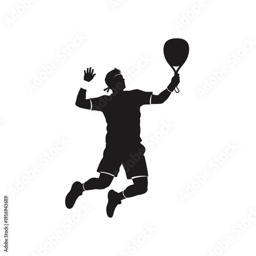 Silhouette of a male padel player jumping and hitting the ball during a match