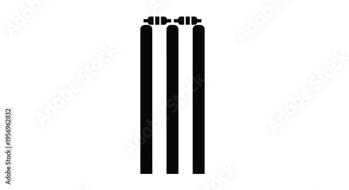 Cricket wickets standing tall in a stark black silhouette