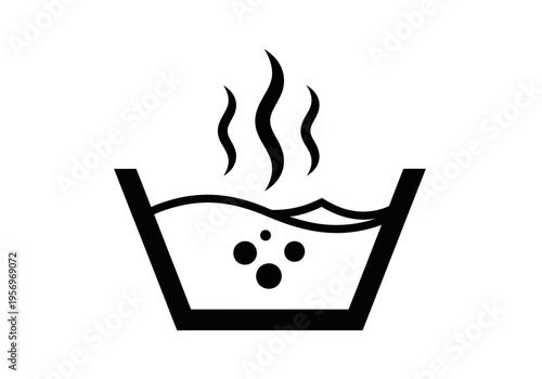 A steaming bowl of hot water with bubbles rises from the container indoors.