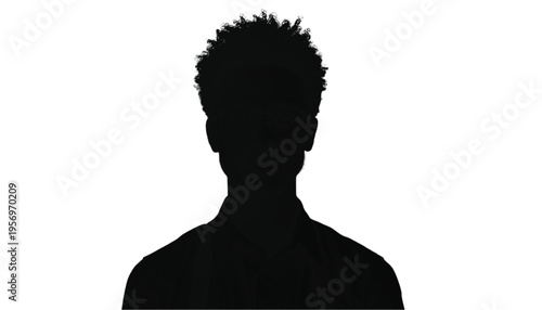 A solitary silhouette of an African American man with tightly curled hair stands against a bright white.