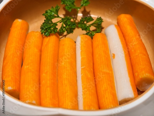 Close-up imitation crab sticks arranged in a bowl