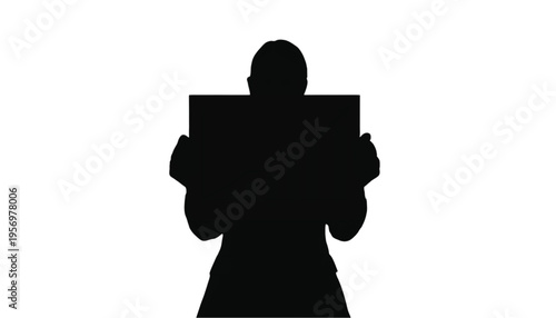 Single person silhouette holds up a blank rectangular sign or placard directly facing forward on white.
