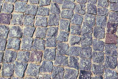 Cobblestone street surface showing unique patterns and colors in a historic town during daylight in spring
