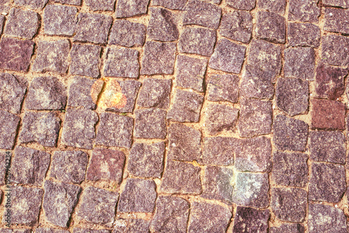 Cobblestone street surface showing unique patterns and colors in a historic town during daylight in spring