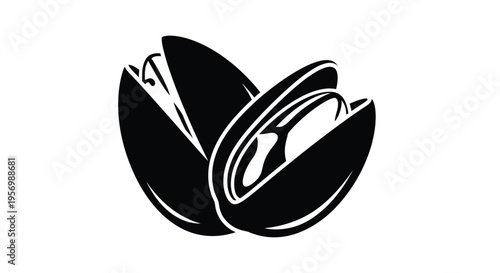 Opened pistachio nut with shell fragments a striking black silhouette