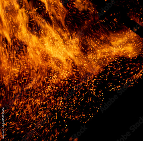A fire is burning and the smoke is creating a lot of sparks