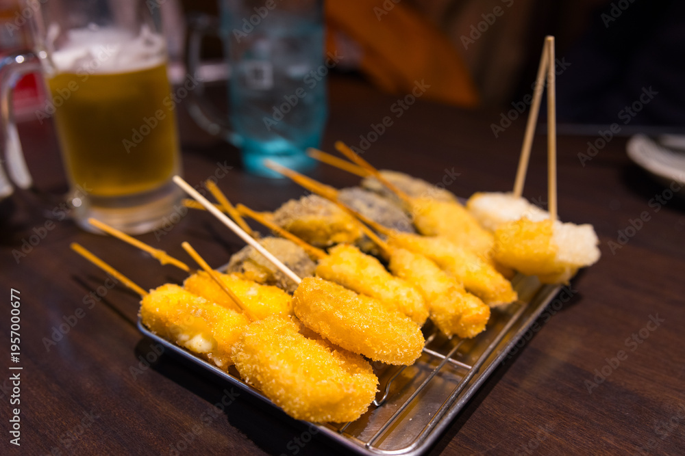 Naklejka premium Japanese street food osaka kushikatsu on skewers