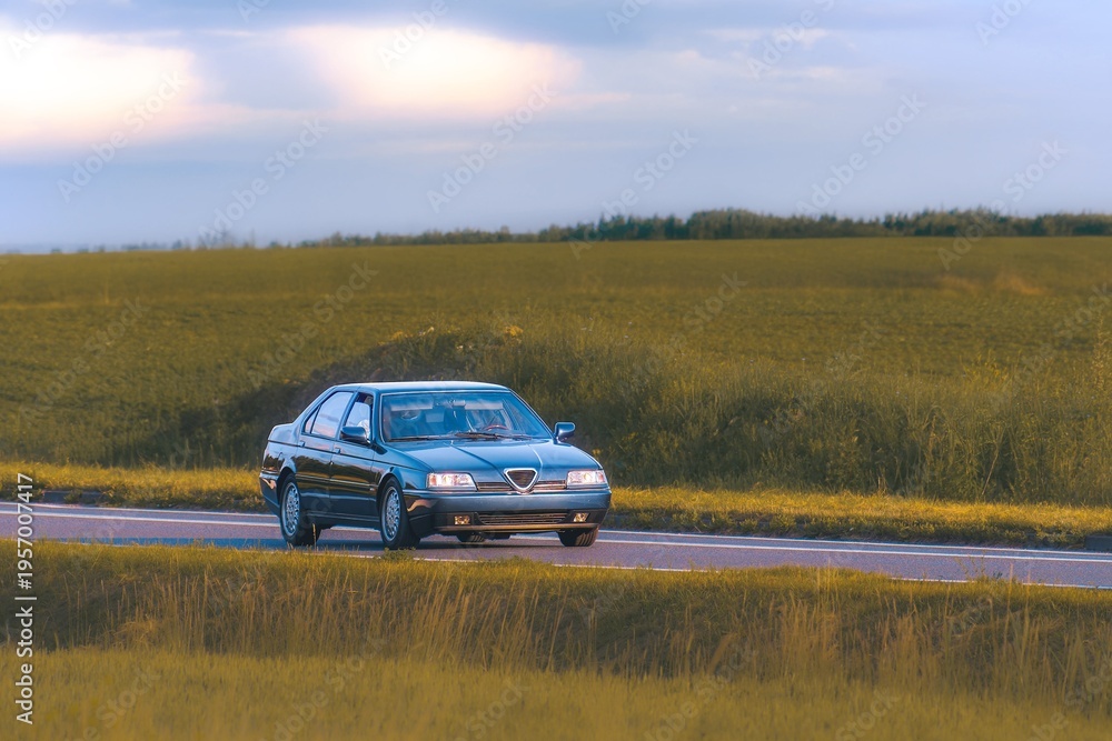 Fototapeta premium Beautifully preserved 90s style car on open highway