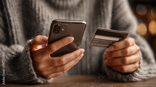 Online Payment with Smartphone: A close-up shot of a hand securely holding a smartphone and credit card, highlighting the ease and convenience of digital transactions.