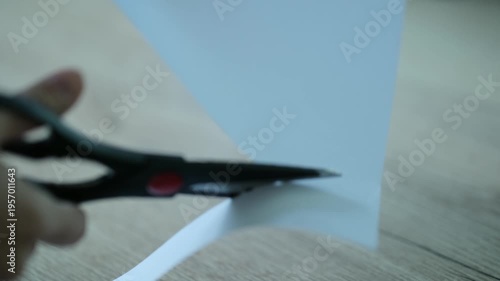 I'm cutting white paper with scissors.