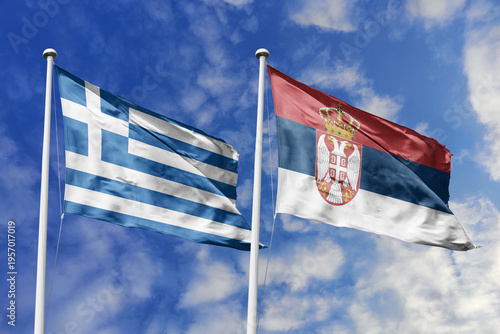Photos Greece and Serbia flags waving in a clear blue sky, symbolizing a powerful diplomacy, expanding global trade, a strategic partnership, and a shared vision of unity for a sustainable future