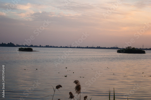 Calm lake sunset with soft sky reflection landscape
