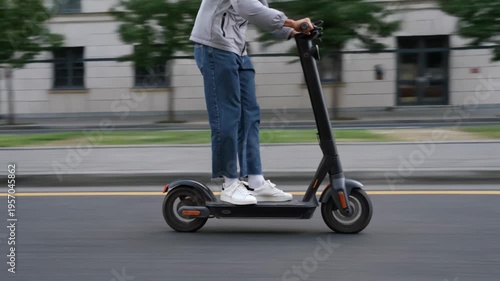 A man riding an electric scooter through a sunny urban park with motion blur, capturing sustainable transportation and modern commuting.