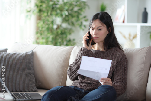 Angry asian woman making phone call about letter