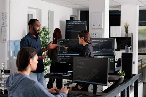 App software developer typing machine learning html code on computer, sitting at desk in it big data office. Cloud programer working on database system with coding script in software company,