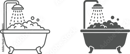 Vintage clawfoot bathtub overflowing with soap suds and water from an overhead shower head shows bathing luxury.