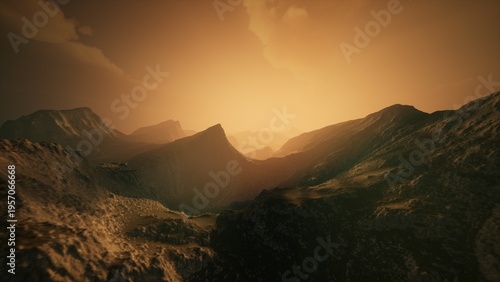 Photos As the sun sets, the horizon glows with warm golden tones illuminating rugged mountains and valleys