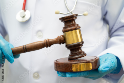 Tableau sur toile Asian doctor holding court hammer for and crime law justice, forensic medicine