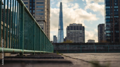 Urban Landscape with Modern Buildings and Towering Structure in the Background Captured During Daytime with Blue Sky and Clouds