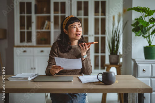 Photography Woman multitasking working from home sending voice message