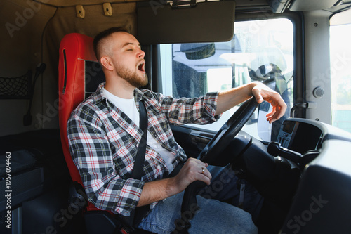Obraz w ramie Tired truck driver yawning feeling fatigue while driving