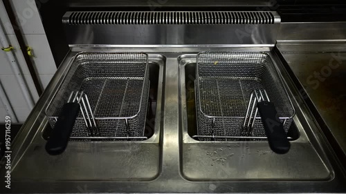 Professional deep fryer slowly advancing in a restaurant kitchen