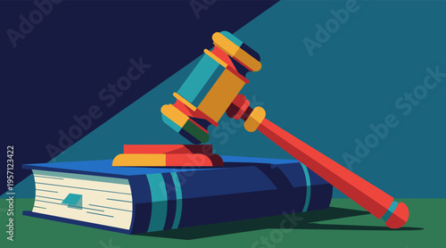 Gavel resting on law book on wooden table with shadow
