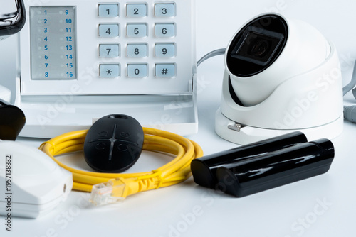 Different gadgets and equipment for home security system setup on a table