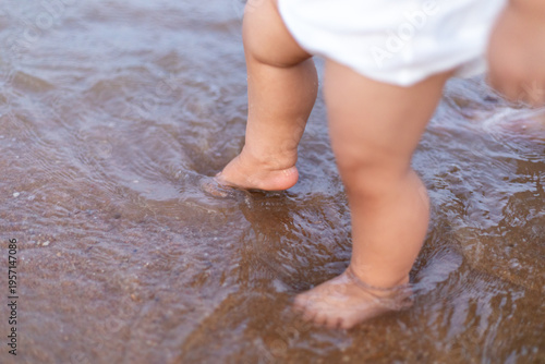 A young child playing in the water at the beach