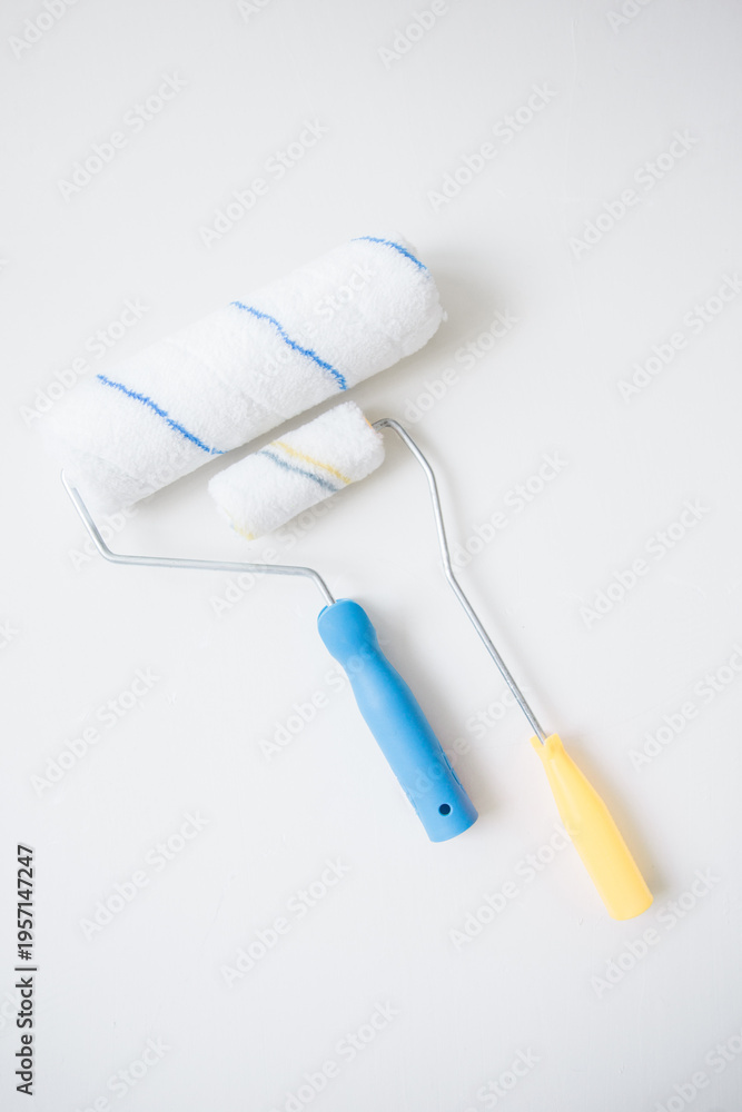 Obraz premium Paint rollers on a white background for home renovation and DIY painting. 