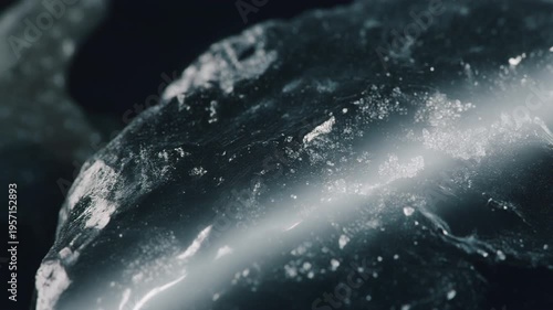 White glowing fracture through icy black rock texture