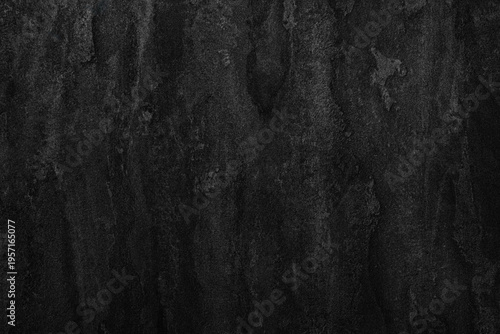 Deep charcoal texture, rough and gritty surface. Mottled shadows add depth and character. Ideal for backgrounds or abstract design projects. Suitable for themes of mystery, decay, or urban grit