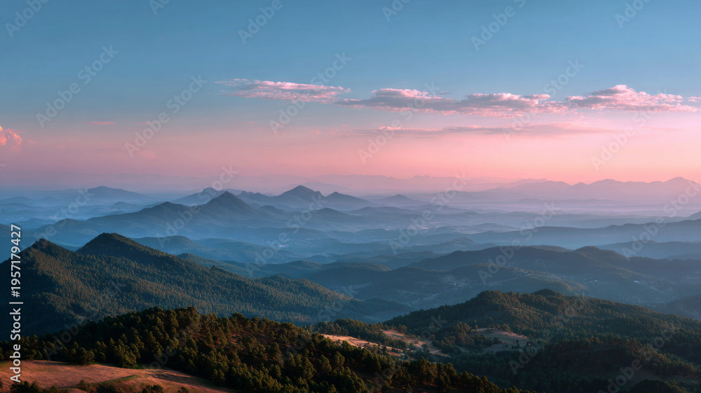 Fototapeta premium Soft haze covers distant mountain range under pastel sky at sunset, tranquil and serene landscape