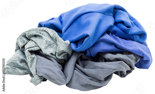 A messy heap of blue and gray clothing is placed on a clear surface. The wrinkled fabric suggests it has just come out of a laundry cycle, ready to be sorted or folded