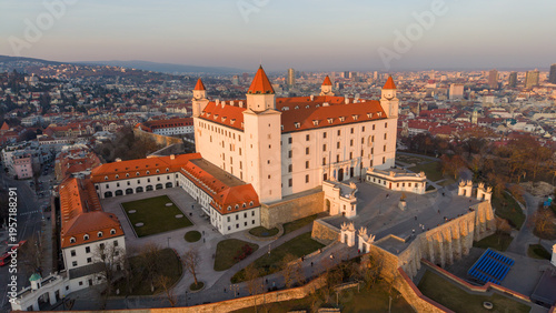 Photography Elevated drone view of Bratislava Castle courtyard with city skyline in the background during golden hour