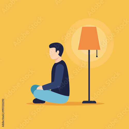 Person sitting cross-legged on the floor beside a standing lamp.
