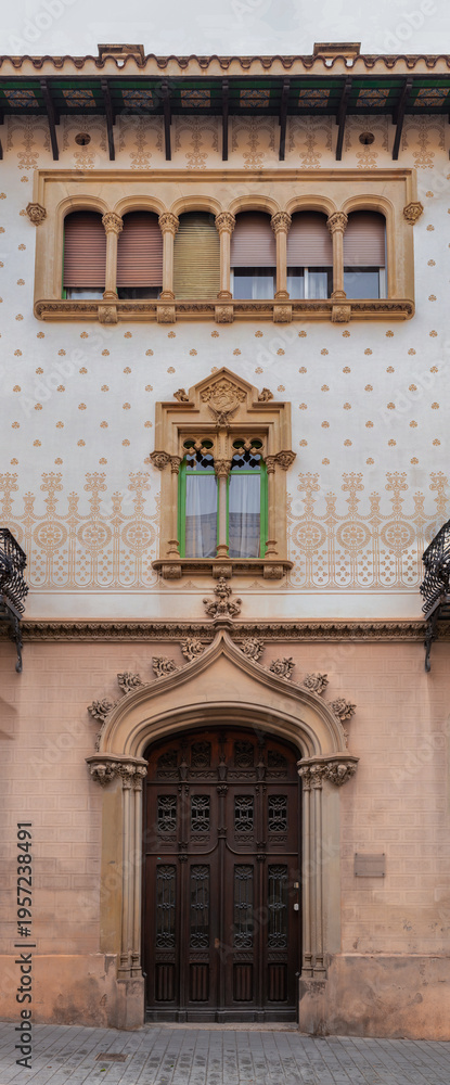 Obraz premium Elements of architectural decoration of buildings, doorways and arches, doors and grills, plaster patterns and stucco molding. On the streets in Barcelona, ​​public places.