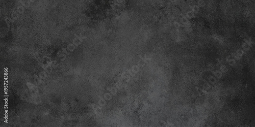 A dark grunge concrete wall background featuring a weathered black stone texture and old gray paper patterns on a rough aged surface with blank copy space for design