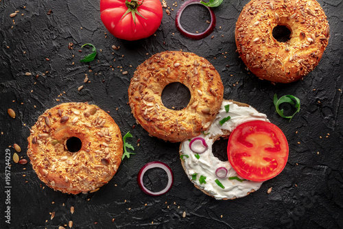 Wallpaper Mural Vegetarian bagels with tomato and onion, overhead flat lay shot on black Torontodigital.ca
