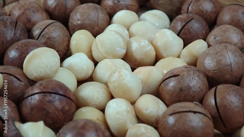 Macadamia nuts are in a wooden plate.