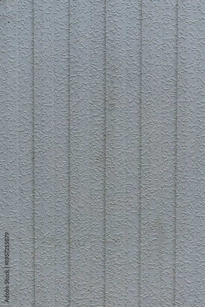 Fototapeta premium Grey vertical textured wall with subtle relief pattern