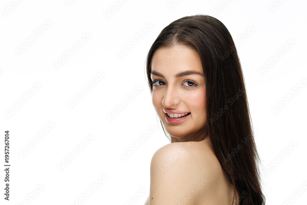 Fototapeta premium Portrait of young woman with radiant skin gently touching her face. Natural beauty concept.