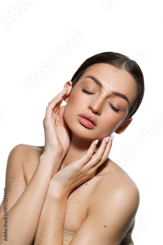 Natural beauty concept. Young woman with glowing clean skin smiling at camera on white studio background
