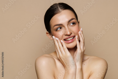Beautiful young woman after spa treatment on beige background