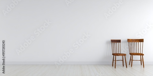 Two Wooden Chairs Against A Plain White Wall And Floor interior room