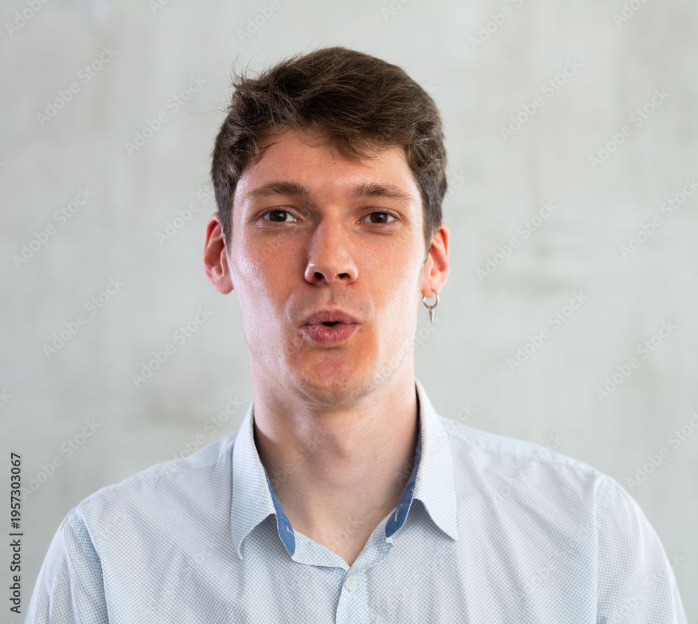 Fototapeta premium Emotions, people and positive concept man expresses different on gray background